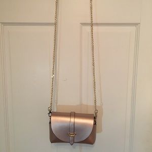 Rose gold convertible crossbody clutch.